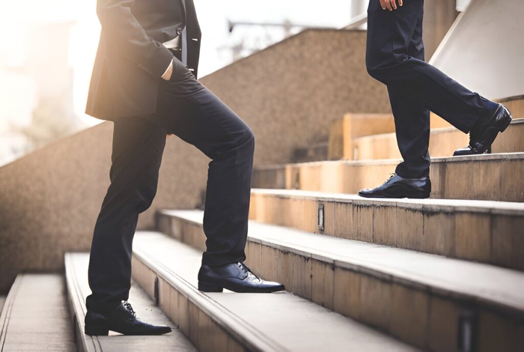 A determined man climbing stairs labeled “Success,” representing the importance of action.