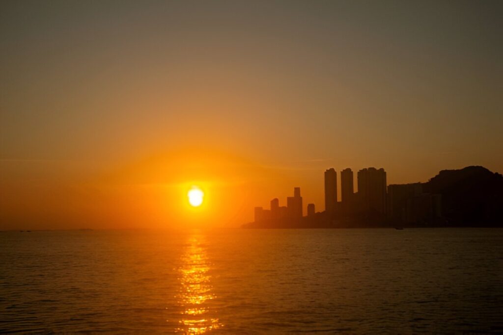 A vibrant image of a sunrise over a city skyline, symbolizing new beginnings and Tuesday motivation.